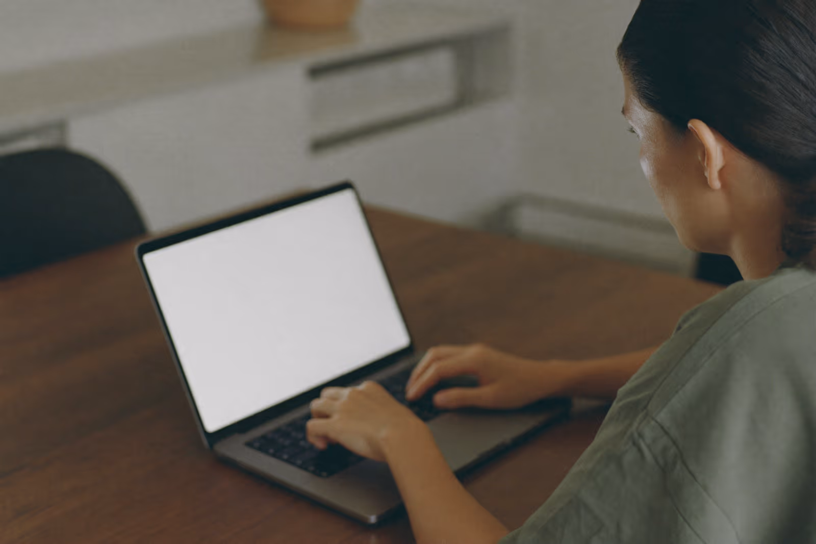 A person completing an online health questionnaire at a kitchen table